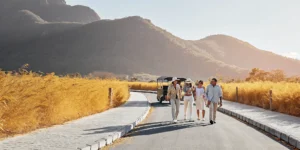 Multi-day tour group hiking through scenic mountain landscape with tour guide