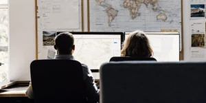 Tour operator operations team reviewing a dashboard of agent and wholesaler tour bookings