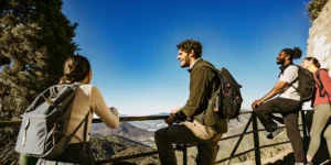 Tour group with a local guide at a scenic mountain overlook, illustrating how tour operator reservation systems work
